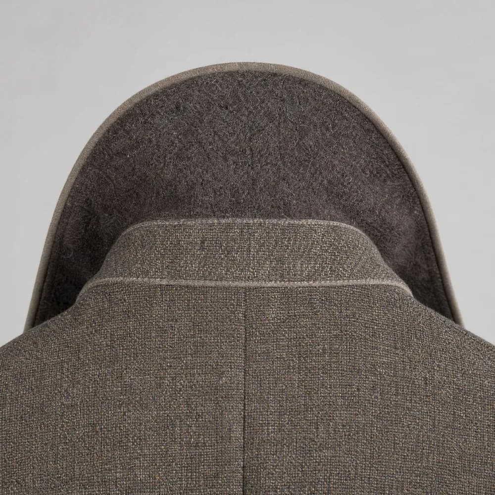 The undercollar and collar stand of a jacket turned up, showing the felled stitching.