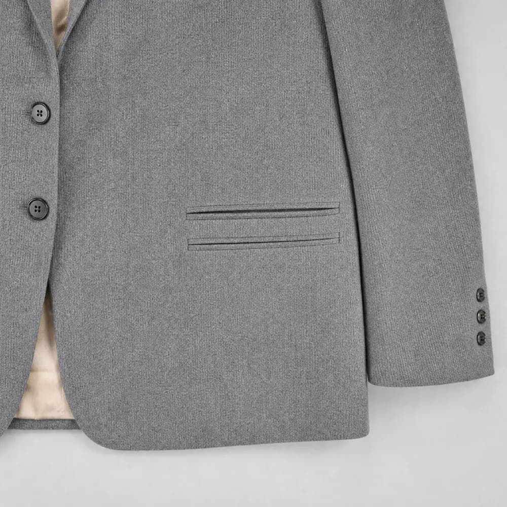 A double-welt besom hip pocket with no flap, photographed flat from above.