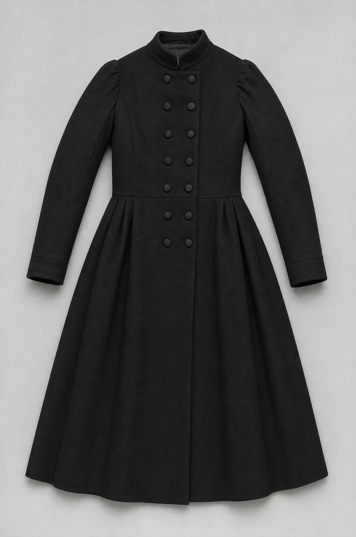 A long black wool frock coat laid flat and symmetrical, with a waist seam and full skirt.