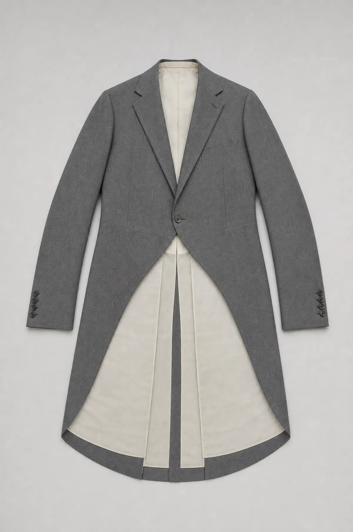 A grey morning coat laid flat, the front cut away in a curve to long back tails.