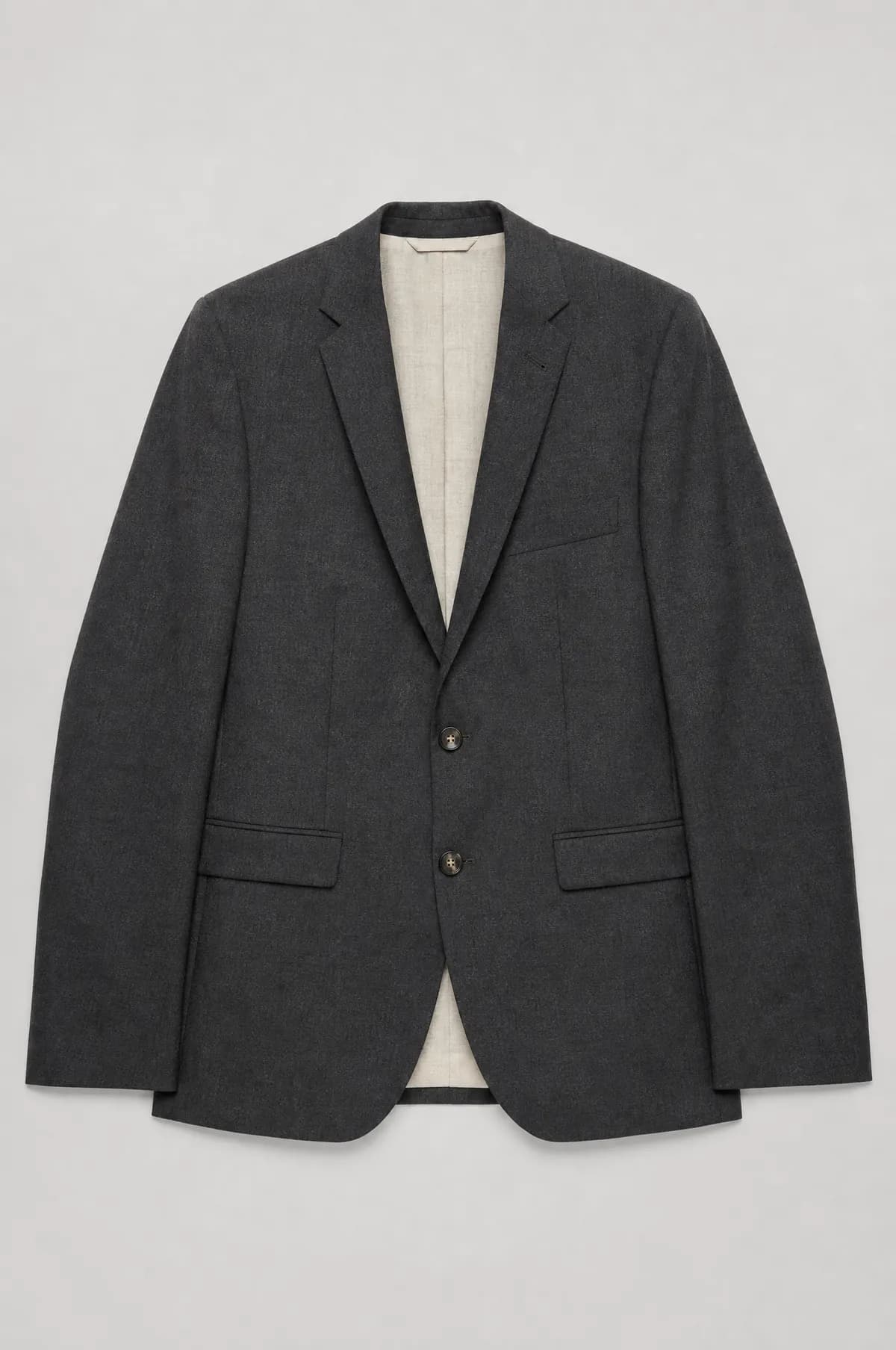 A charcoal two-button jacket laid flat with narrow shoulders and slim lapels.