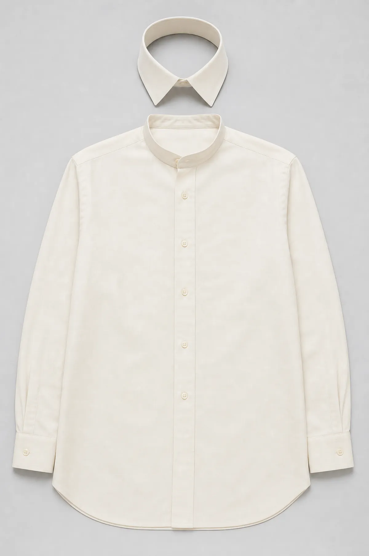 A cream cotton dress shirt laid flat with a detachable stiff collar placed above the neckband.